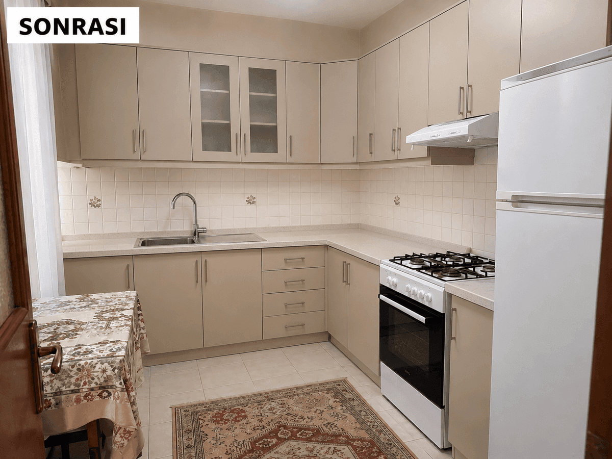 Mersin mutfak dolabı yenileme sonrası — krem düz kapaklar, cam detaylı üst dolaplar ve aydınlık mutfak
